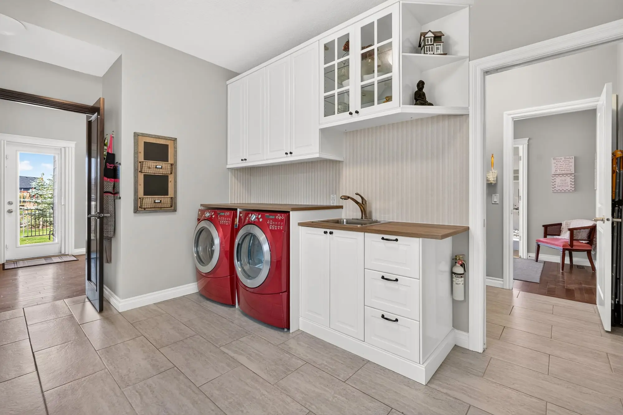 Laundry room with sink and upper cabinets