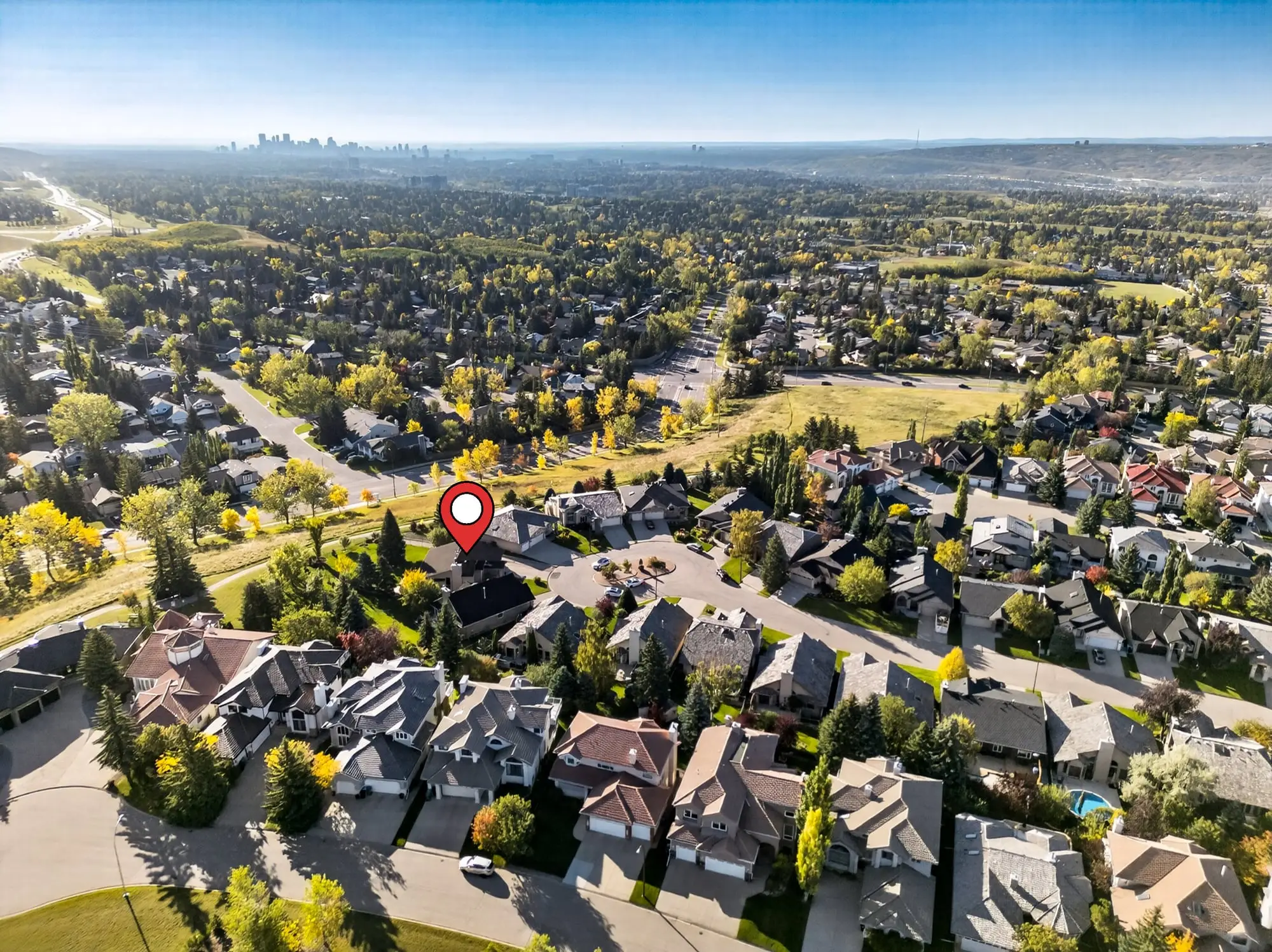 Aerial view with the property pinned, downtown beyond