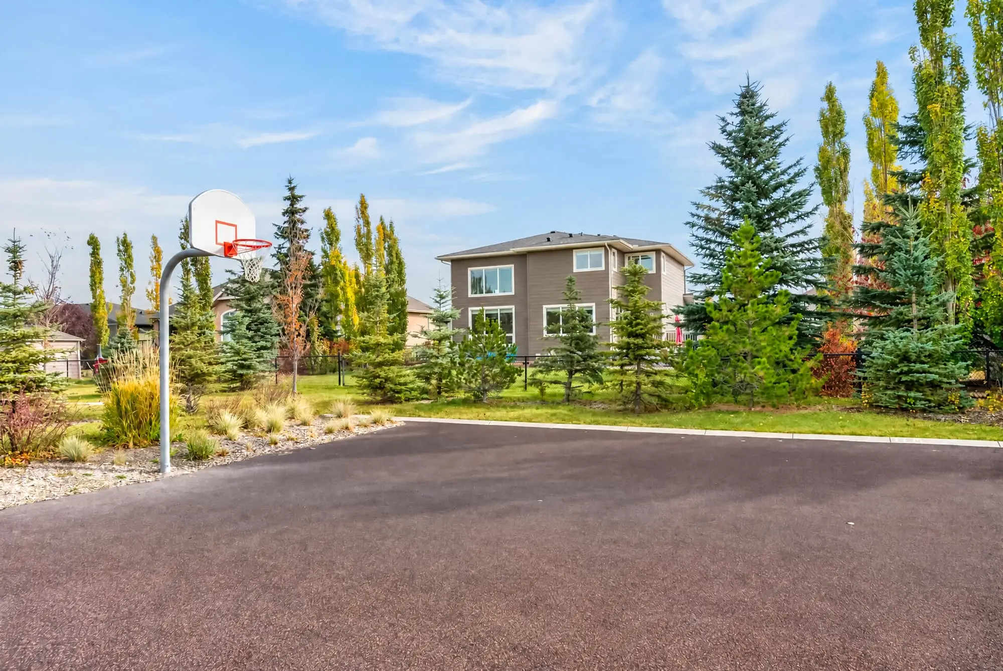Basketball court on the green space behind the home