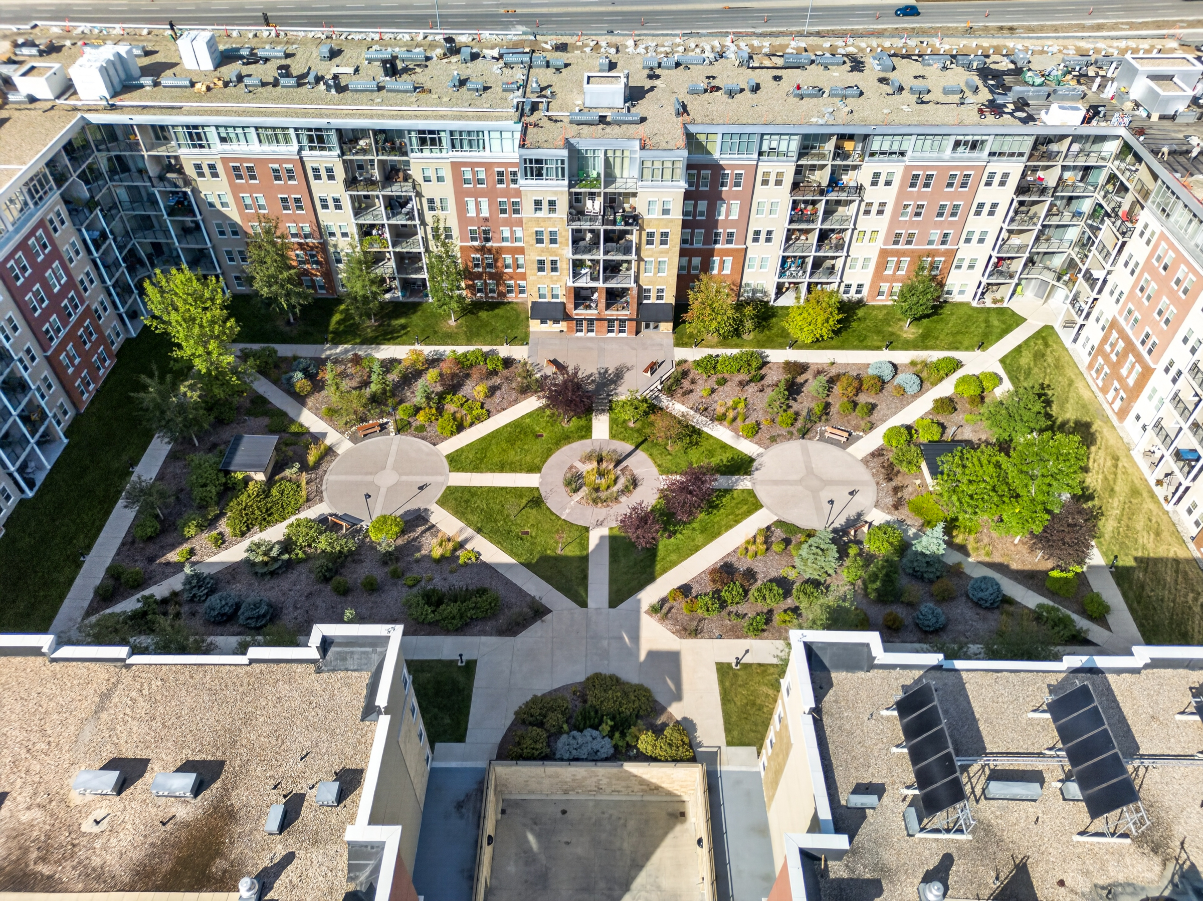Straight-down aerial photograph of a Calgary condo courtyard and landscaped grounds