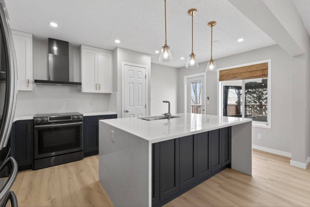 Bright white open concept kitchen with dark blue highlights